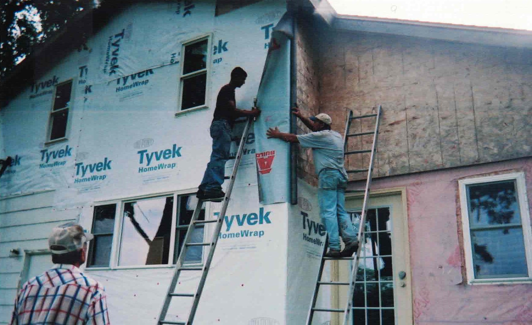 Early Toppin Construction crew installing house wrap on a residential build